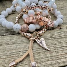 Boho Blush Bracelet Stack – where the enchanting hues of rose gold and pristine white hues come together in a whimsical dance of elegance and boho charm. This stack isn't just jewelry; it's a serenade to your free-spirited soul. Treat yourself with the Boho Blush Stack and let each bracelet tell a tale of carefree grace. So Pretty!! Wear them all on one wrist and stack 'em up or wear 3 on one wrist and two on the other with a watch! Lead & Nickel Free Bracelets are 'one size fits most' and are designed to fit wrists up to 7.5" comfortably Stretch bracelets set of 5 Off White and Rose Gold Hues Pave Crystal Embellishment Heart Charm with Leather Fringe Pull Please be aware that due to the unique and handmade nature of each product, colors, shapes, and bead sizes may vary slightly from the p Feminine Adjustable White Jewelry, Feminine White Adjustable Jewelry, Bohemian White Bangle Jewelry, Feminine White Beaded Bracelets, Feminine White Beaded Bracelet, Adjustable White Beaded Feminine Bracelets, Adjustable Spiritual Rose Gold Jewelry, Elegant Silver-colored Copper Bracelets, White Bohemian Stackable Bracelets