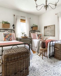 a bedroom with two beds and baskets on the floor