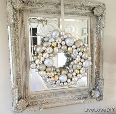 a christmas wreath hanging on the side of a mirror