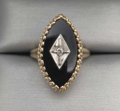 This vintage ring features a (20 x 11.5mm) marquise black onyx with a tiny genuine, natural diamond in a tray of white gold.  Crafted in 10k yellow gold.   Hallmarked: 10K  Size = 6 1/4 Ask us about re-sizing.  Weight = .16 oz. or 5.0 grams.  IMPORTANT NOTICE:  If you would like to inquire about re-sizing, please message us and wait for a response before you finalize your purchase.  If the re-sizing is possible we then add the re-sizing fee to your total before you finalize your purchase.  We do not accept returns or exchanges. Our items are accurately described and guaranteed. Contact us if there is an issue with your order.  If you have any questions, just ask. We love hearing from our customers!   Favorite our store for more unique finds and great deals! Black Onyx Ring Gold, Vintage Onyx Ring, Natural Ruby Ring, Ring Inspo, Memorial Ring, Custom Memorial, Unique Finds, Onyx Jewelry, Vintage Memory