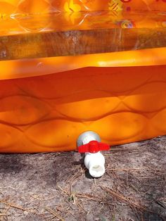 an orange and white object sitting on the ground