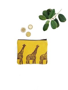 "Coin purse or wallet for cards, bills and coins, with a handmade giraffe print. Women's wallet belonging to the \"The Pond\" collection by Made in Tarrío. 👝 CHARACTERISTICS: This pretty purse or wallet is printed and handcrafted with our own illustration of giraffes, the most elegant in the savana. Handmade printing with ecological inks on mustard cotton canvas. We use brown ink to stamp the giraffes. Each giraffe is made one at a time. The back of the purse is brown, made of smooth fabric with a soft texture. Inside, it has a double pocket to separate cards from folded bills and coins. Main clousure with a gold metal zipper. The lining inside is made of flowers, which contrasts with the dark tones of the wallet (the color of the lining may vary depending on availability). 📏 MEASURES: T Woman Wallet, Octopus Design, Vegan Wallet, Fabric Wallet, Giraffe Print, The Pond, Money Clip Wallet, Giraffes, Wallets For Women