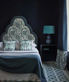 a bed with blue and green decor in a bedroom