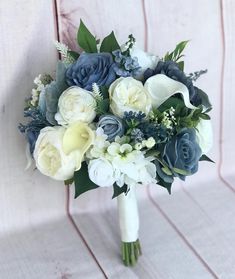 a bridal bouquet with blue and white flowers