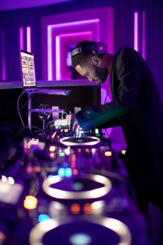 a man in headphones is playing music on a dj's turntables