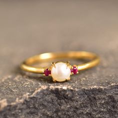 Fresh Water Pearl And Ruby Dainty Wedding Ring Handmade Statement Ring June Birthstone Round Shaped Ring Gifts For Her White Gemstone Ring Welcome to Rockstiffart Experience stunning jewelry which compliments your style everyday, All the items in my shop are hand made items and are crafted by our Master Goldsmith in our workshop, We pay a lot of emphasis on the making of the ring and we always assure you that we will provide best quality products every time toy you, Detailed description of the p Delicate Gemstone Jewelry For Anniversary, Classic Pearl Ring With Birthstone For Wedding, Elegant Stackable Ruby Ring For Wedding, Elegant Stackable Ruby Wedding Ring, Classic Pearl Wedding Ring With Birthstone, Classic Wedding Pearl Ring With Birthstone, Open Ring Gemstone Jewelry For Wedding, Yellow Gold Pearl Ring With Birthstone For Wedding, Gemstone Open Ring For Wedding