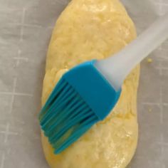 a blue and white brush sitting on top of dough