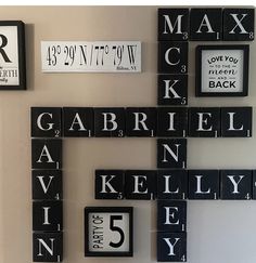 a cross made out of scrabble tiles with numbers and letters on the wall