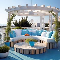 a white and blue couch sitting on top of a wooden deck