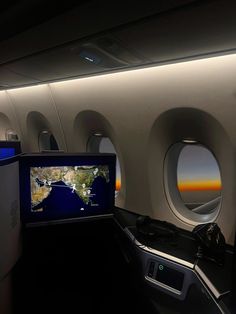 the inside of an airplane with two televisions