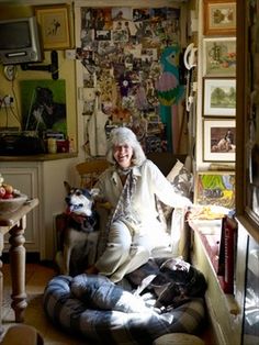 an older woman sitting on a bean bag chair with two dogs in front of her