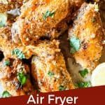 air fryer fried chicken wings with parsley and lemon wedges on the side