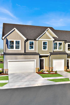 this is an image of a two story house with garages on the first floor