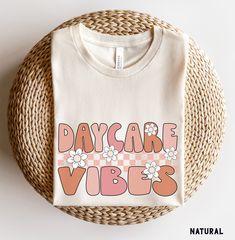 Daycare Vibes Shirt, Daycare Teacher Shirts, Daycare Crew Shirts, Back to School Shirt, Retro Daycare Tee, Daycare Teacher Gift More Grades and Styles Here: https://www.etsy.com/shop/TheGraphicPeach?ref=seller-platform-mcnav§ion_id=34195008 For environmental and human friendly reason, this product is only made when you order. Turnaround time is usually 1-5 business days before shipping, but can increase during holiday periods. Our professional printers always strive to ship as quickly as possible, but faster times are not guaranteed. Our printer uses direct-to-garment printing to make our products. The design ink is sprayed on, then allowed to soak into the fibers of the garment. This process yields fine quality prints and a smooth finish on the garment. BELLA + CANVAS UNISEX T SHIRT The B Daycare Teacher Shirts, Daycare Teacher Outfits, Preschool Vibes, Daycare Teacher Gifts, First Day Of Preschool, Preschool Teacher Shirts, Crew Team, Daycare Teacher, Preschool Teacher