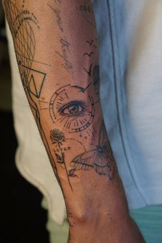 a person with a tattoo on their arm and an eye in the middle of his arm