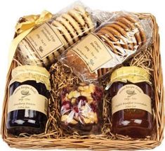 a basket filled with jams and crackers next to bread in it's wrapper