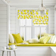 a bright yellow window seat in a white room