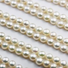 pearls are lined up on a white surface