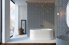 a large white bath tub sitting next to a window