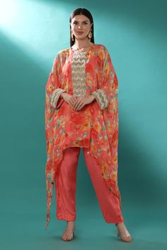 Pink georgette kaftan with floral print and badla, pearls and cutdana embroidered placket and cuffs. Comes with shantoon pant and an inner.
Components: 3
Pattern: Printed, Embroidered
Type Of Work: Floral, Badla, Pearls, Cutdana
Neckline: Round
Sleeve Type: Kaftan : Flared Sleeves, Inner : Sleeveless
Fabric: Shantoon, Kaftan : Georgette, Lining : Shantoon
Color: Pink
Other Details: 
Attached lining
Length :
Kaftan : 30 inches (Front) and 54 inches (Side)
Pant : 38 inches
Product Weight : 1 Kg
Oc Georgette Kaftan, Embroidered Kaftan, Side Pants, Pant Set, Set For Women, Flared Sleeves, Aza Fashion, Sleeve Type, Pants Set