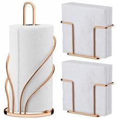 three white napkins and two gold metal holders