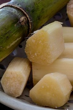 a banana sitting on top of a white plate next to pieces of fruit in it