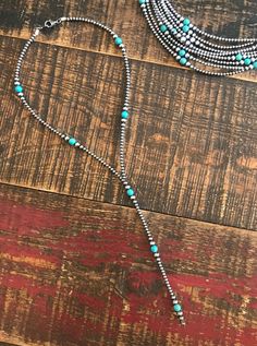 Women's Sterling and Turquoise Y Necklace The Callison Lariat from Calli Co Silver Product Details Sterling silver and turquoise 3 to 6mm beads 5 1/2" lariat drop Lobster clasp Please select length. Shop more from our Necklace collection, here.