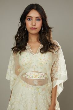 French vanilla raw silk sharara cum palazzo, hand embroidered with cutdana and colorful sequins in floral pattern. Comes with embroidered padded bustier, hand embroidered bohemian kaftan and belt.
Component: 4
Pattern: Hand Embroidered
Type Of Work: Floral Appliques, Sequins Cutdana
Neckline: Sweetheart
Sleeve Type: Batwing Sleeves
Fabric: Raw Silk, Silk Organza
Color: Ivory
Other Details: 
Floral patters
Adjustable bustier straps
Back smocked bustier
Scalloped hem kaftan
Approximate product wei Silk Sharara, Kaftan For Women, Palazzo Set, French Vanilla, Silk Organza, Floral Applique, Scalloped Hem, Suit Fashion, Color Ivory