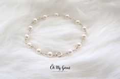 "Elegant white pearl bracelet delicately hand wrapped to form a handmade chain. Made with genuine Swarovski white pearls (5mm). This dainty bracelet is perfect for weddings or everyday occasion. It is also the birthstone for June. CHOOSE YOUR PEARL COLOR (see photo #7) 1) White - as pictured 2) Pearlescent white - iridescent shimmer 3) Cream  CHOOSE TYPE OF FINISH: 1) Sterling silver - made with sterling silver wire and sterling silver spring clasp 2) Silver plated - made with silver plated wire Handmade Elegant Sterling Silver Pearl Bracelet, Minimalist Sterling Silver Pearl Bracelet For Wedding, Delicate White Pearl Bracelet For Anniversary, Dainty White Gold Pearl Bracelet, Dainty Silver Beaded Bracelets With Pearl Chain, Handmade Sterling Silver Bracelet In White, Handmade White Sterling Silver Bracelet, Dainty White Beaded Bracelet For Anniversary, White Sterling Silver Pearl Bracelet As Gift