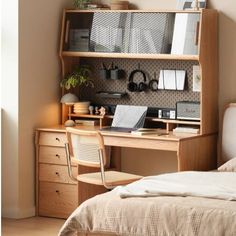 a bed sitting next to a desk with a laptop computer on top of it in a bedroom