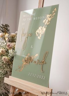 an easel with a sign that says welcome to the bride and groom