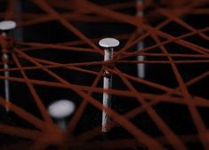 a close up view of the top of an umbrella with strings attached to it in dark room