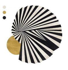 a black and white rug with gold circles on it's center piece, in the middle of an abstract design