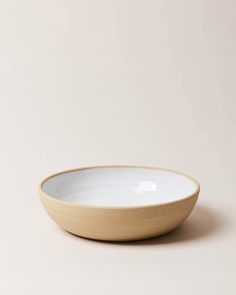 an empty white bowl on a beige background