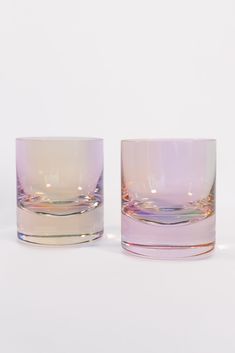 two glasses sitting next to each other on a white surface