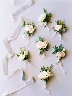 wedding flowers laid out on a white table