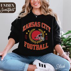 Stay cozy in this Kansas City football sweatshirt! A perfect blend of vintage and trendy style, this crewneck is ideal for game day or as a gift for Chiefs fans and football lovers. Go Chiefs! Hey there! 😊👋 Looking for a cozy sweatshirt? You're in the right spot! I'm here to make your shopping experience awesome, so if you have any questions or just want to chat, feel free to reach out anytime. Here's why you'll love these sweatshirts:  ⭐ Cozy & Comfy: 50% cotton, 50% polyester blend (8.0 oz/yd²) for those chilly days.  ⭐ Stylish Fit: Classic crewneck, perfect for any look.  ⭐ Durable: Double-needle stitching means it lasts!  ⭐ No Tag Itch: Tear-away label for extra comfort.  ⭐ Eco-Friendly: Ethically sourced with 100% US-grown cotton & eco-friendly dyes. How to order:  -> Check out the Vintage Kansas City, Kc Football, Kansas City Football, Football Sweater, Sweatshirt Trendy, Football Sweatshirt, Football Lovers, Sweatshirt Vintage, Trendy Style