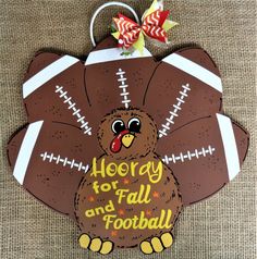 a turkey shaped ornament with footballs on it's back and the words, hooray for all and football