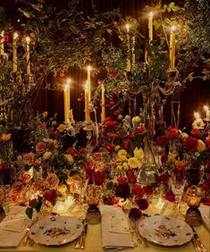 the table is set with flowers and candles for an elegant dinner or party event,