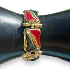 This is an IVANA signed ruby red and emerald green enamel organic design stations bracelet in a shiny gold tone cast metal alloy. Signed: IVANA© on the back.  Measures - 8" Weight - 1.4 ounces Pics are part of our description. Please view the ENTIRE listing carefully as we don't offer returns. If you have any questions, please ask us BEFORE purchasing. We're happy to answer you.  Located at MyStyle Boutique. Open Mon-Sat 10-5 at 11000 70th Ave. Seminole, FL 33772 CLOSET TAGS: vintage jewelry, vi Retro Enamel Bracelets For Gifts, Retro Enamel Bracelets For Gift, Retro Enamel Bracelet For Gift, Retro Enamel Jewelry For Party, Retro Enamel Party Jewelry, Red Metal Costume Jewelry Bracelets, Red Metal Costume Jewelry Bracelet, Fashion 1990s, Fashion 2000s