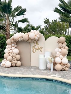 an outdoor pool area with balloons and decorations