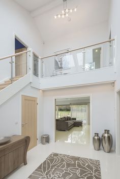 a large living room with white walls and flooring