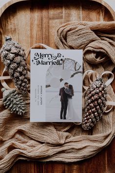 a magazine sitting on top of a wooden tray next to pine cones and twine