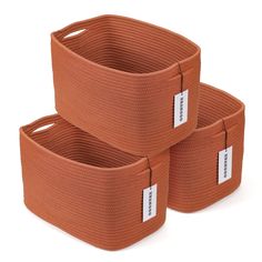 three orange storage baskets with labels on them