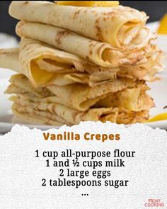 a stack of crepes sitting on top of a plate next to lemon wedges