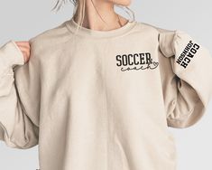 Customize this soccer coach shirt to meet your needs! Choose from short sleeve, long sleeve, hoodies, and crewneck sweatshirts! Other color options and styles are available. If you don't see what you're looking for send us a message! The shirts are a UNISEX retail fit - they are more of a relaxed fit and MAY run a little large on women and those with a smaller frame. Make sure to see the size guides and charts to confirm the best fit for you. We recommend measuring a similar shirt in your closet Long Sleeve T-shirt For Football Season, Casual Long Sleeve T-shirt For Football Season, Coach Sweatshirt, Soccer Coach Gifts, Coach Appreciation, Coach Shirt, Soccer Hoodies, Soccer Coach, Coach Shirts