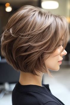 Save this pin for the best layered bob haircuts. Looking for a shorter style with personality? This cut offers exactly that. The short length keeps it fresh, while feathered layers add a touch of softness and volume. Bobs With Volume Short, Stacked Haircuts With Bangs, Ladies Medium Length Hairstyles, Shorter Bob Hairstyles, Center Part Short Hair, Medium Length Angled Bob Haircut, Chin Length Hair For Thick Hair, Short Womens Haircuts With Bangs, Feathered Side Bangs