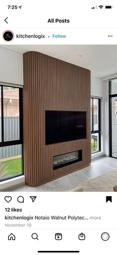 an image of a living room with wood paneling on the walls and fireplace in the middle