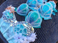 some blue and white ornaments are sitting on top of a mesh tablecloth with flowers