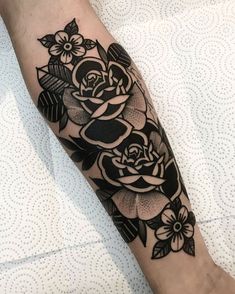 a black and white rose tattoo on the arm